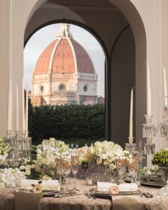 View of the Four Seasons Firenze from the garden, showcasing the stunning architecture and lush surroundings