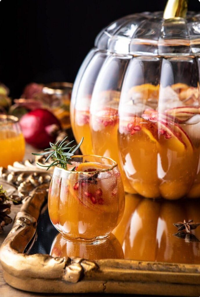Glass bowl filled with delicious punch on a serving tray. Thanksgiving cocktail
