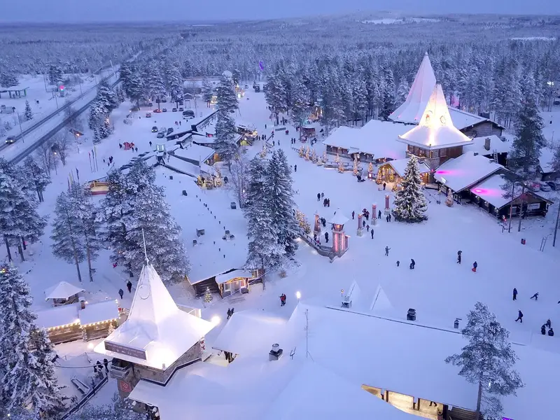 Aerial view of Santa Claus Village in Rovaniemi, with snow-covered rooftops and festive decorations.