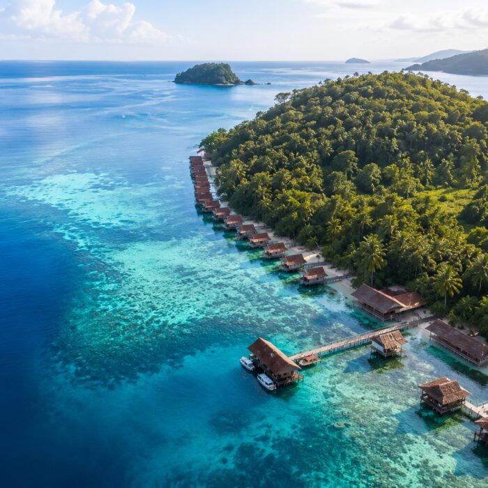 Aerial view of Papua Paradise Eco Resort with overwater bungalows in Raja Ampat, Indonesia.